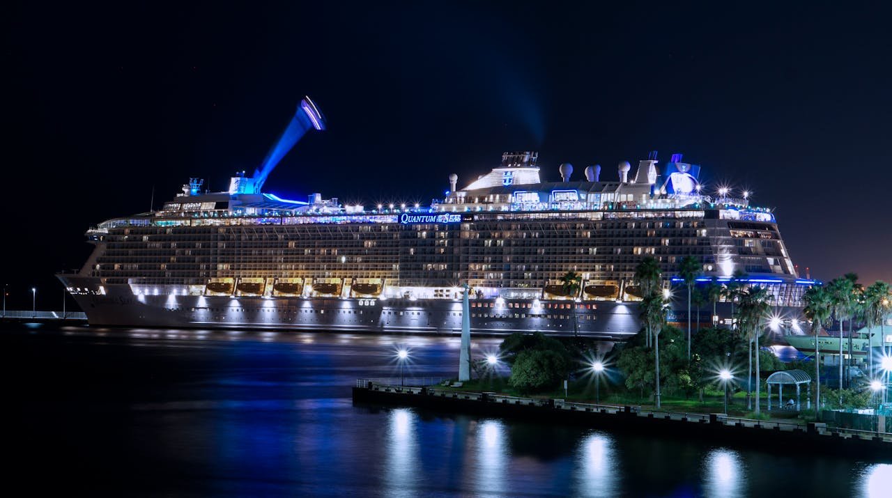 portfolio-02 A stunning view of a cruise ship illuminated and docked at night in Fukuoka harbor.