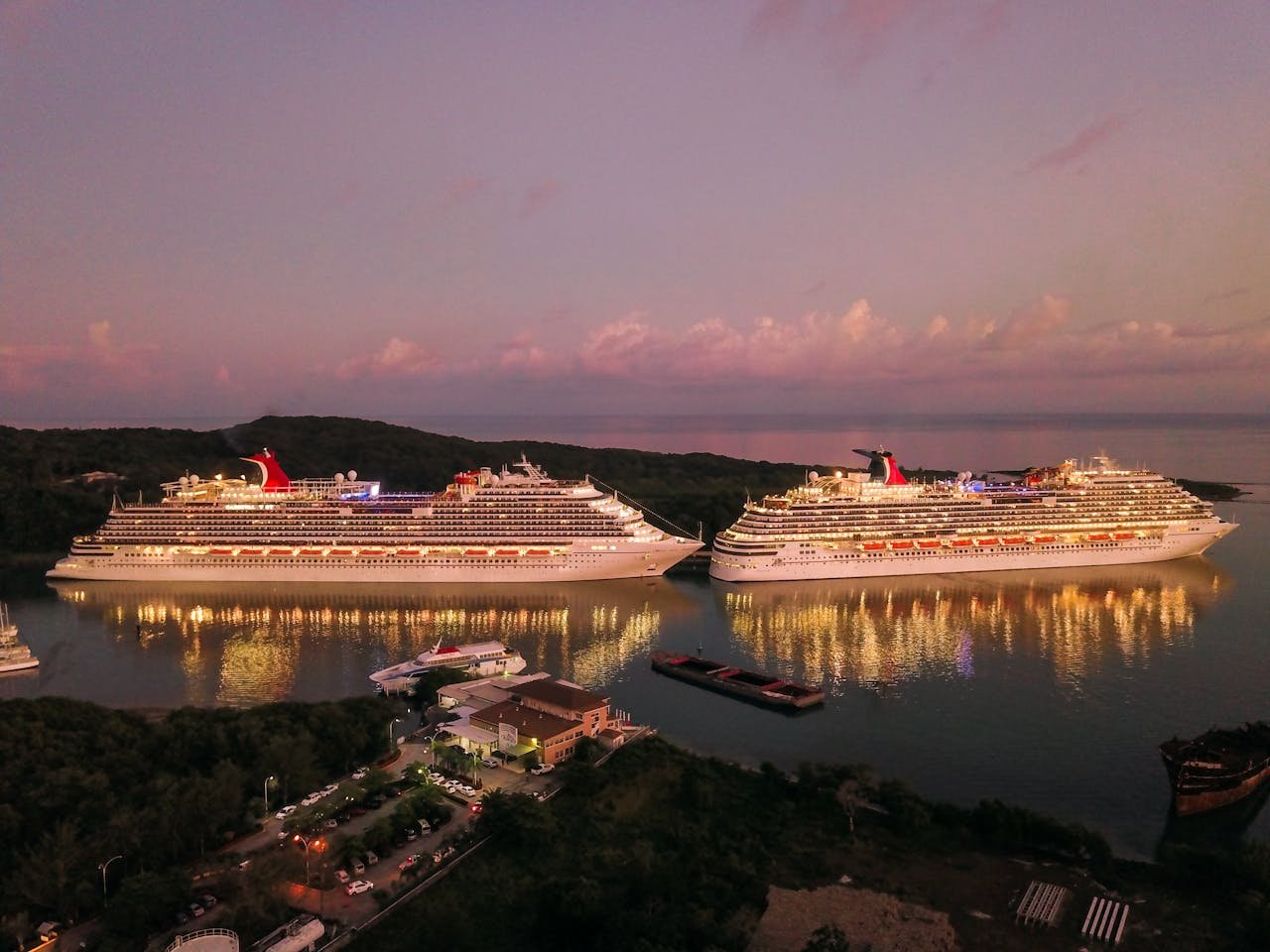 gallery-06 Two illuminated cruise ships docked at Coxen Hole, Honduras during twilight.